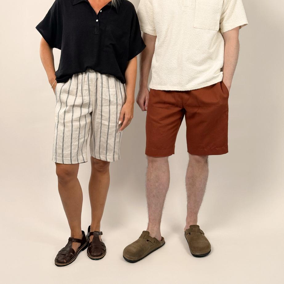 Two people standing side by side against a plain background